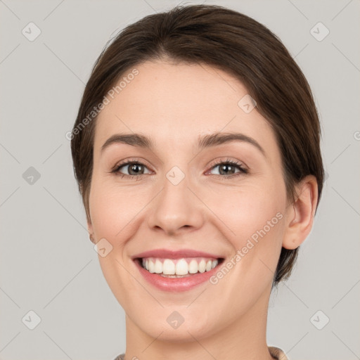 Joyful white young-adult female with medium  brown hair and green eyes