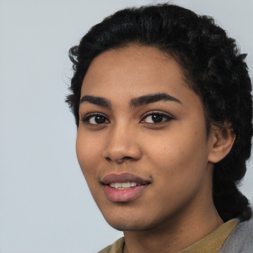 Joyful latino young-adult female with short  black hair and brown eyes