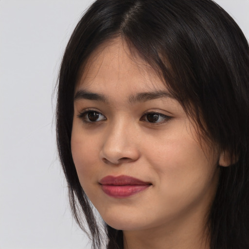 Joyful asian young-adult female with long  brown hair and brown eyes