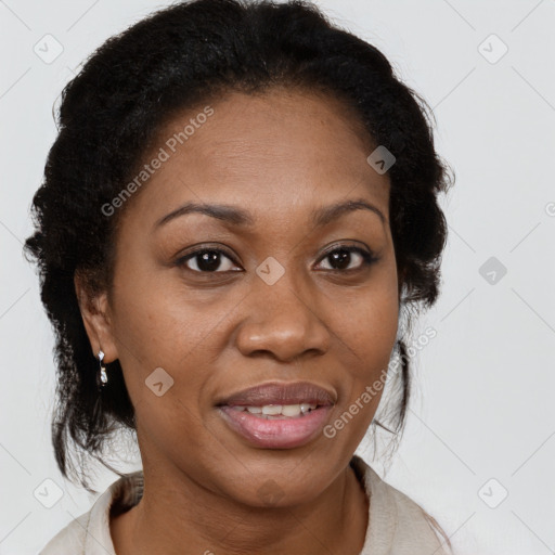 Joyful black adult female with medium  brown hair and brown eyes