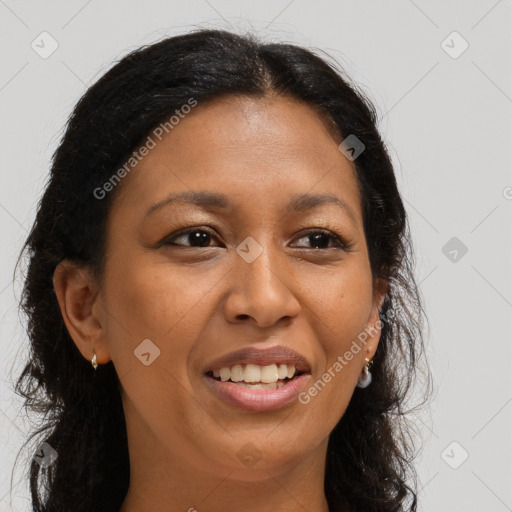 Joyful black young-adult female with long  brown hair and brown eyes