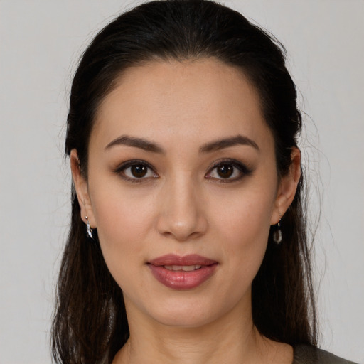 Joyful white young-adult female with long  brown hair and brown eyes