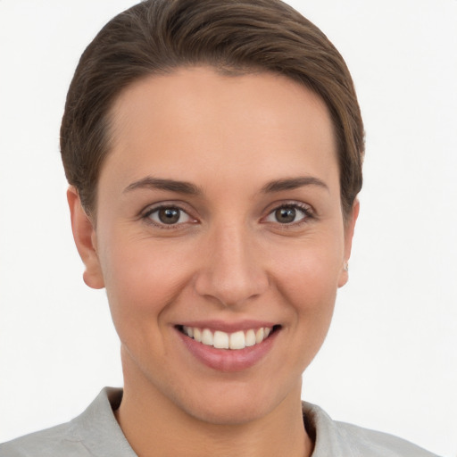 Joyful white young-adult female with short  brown hair and brown eyes