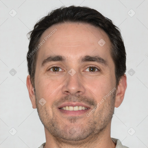 Joyful white adult male with short  brown hair and brown eyes