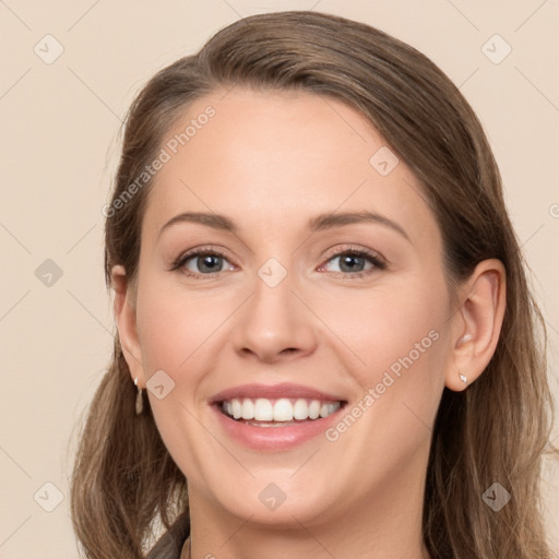 Joyful white young-adult female with long  brown hair and green eyes