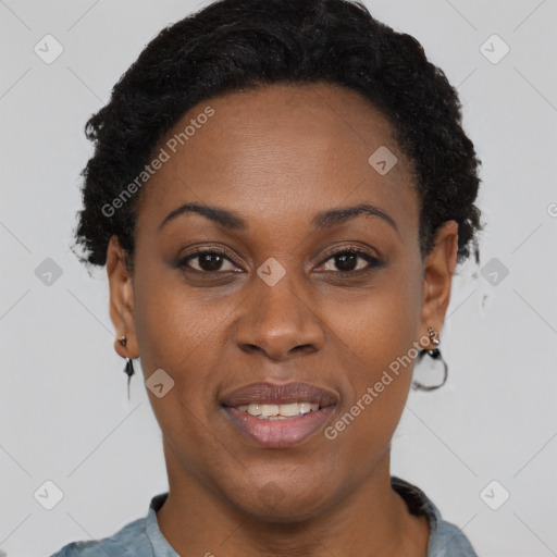 Joyful black adult female with short  black hair and brown eyes