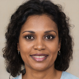 Joyful black young-adult female with medium  brown hair and brown eyes