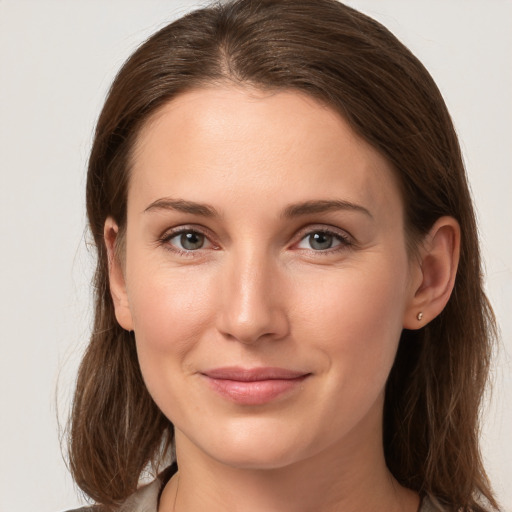 Joyful white young-adult female with long  brown hair and grey eyes