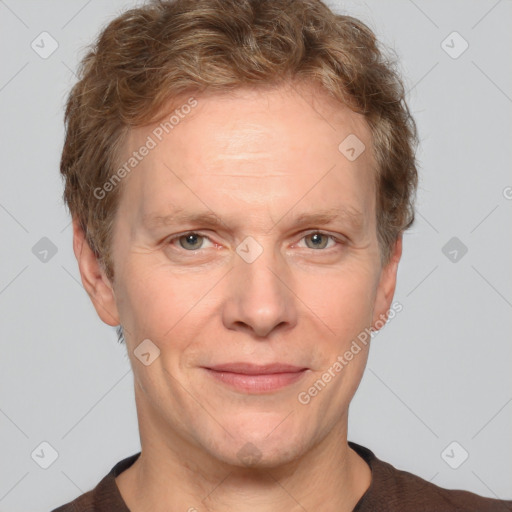 Joyful white adult male with short  brown hair and grey eyes