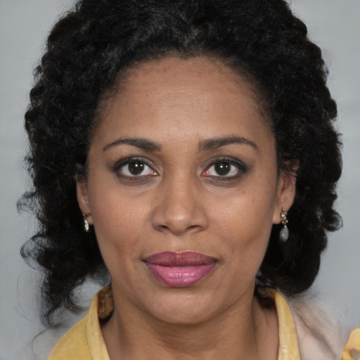 Joyful black young-adult female with medium  brown hair and brown eyes