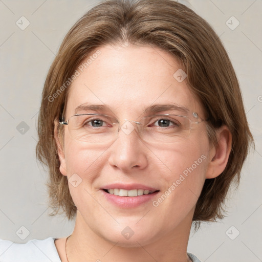 Joyful white adult female with medium  brown hair and grey eyes