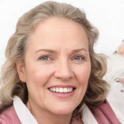 Joyful white adult female with medium  brown hair and blue eyes