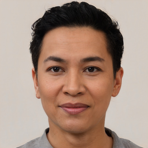 Joyful latino adult female with short  black hair and brown eyes