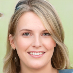 Joyful white young-adult female with long  brown hair and blue eyes