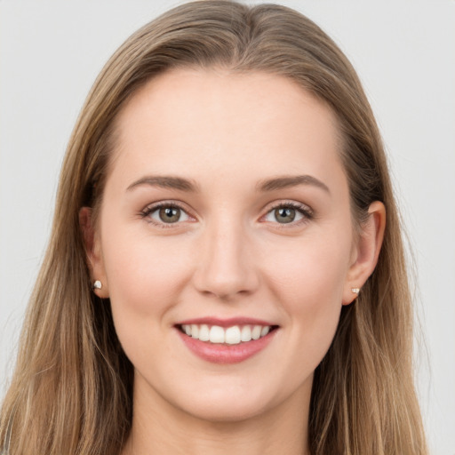 Joyful white young-adult female with long  brown hair and grey eyes