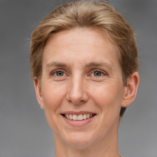 Joyful white adult female with short  brown hair and grey eyes