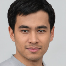 Joyful asian young-adult male with short  black hair and brown eyes