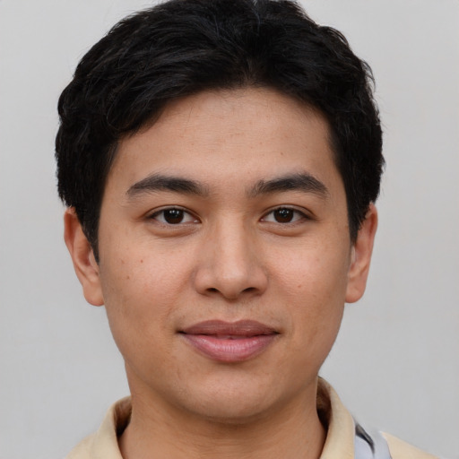 Joyful asian young-adult male with short  brown hair and brown eyes