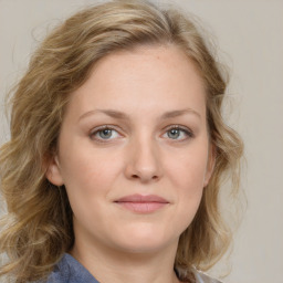 Joyful white young-adult female with medium  brown hair and blue eyes