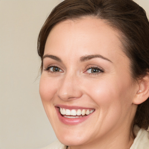 Joyful white young-adult female with medium  brown hair and brown eyes