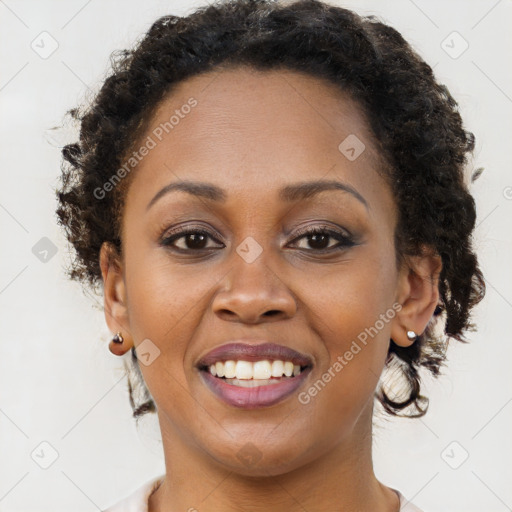 Joyful black young-adult female with long  brown hair and brown eyes