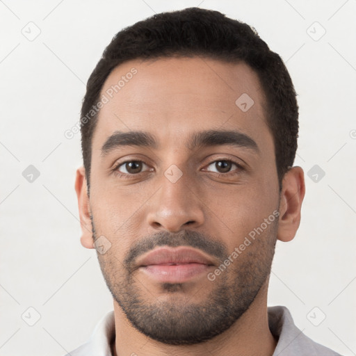 Neutral latino young-adult male with short  black hair and brown eyes