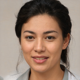 Joyful latino young-adult female with medium  brown hair and brown eyes