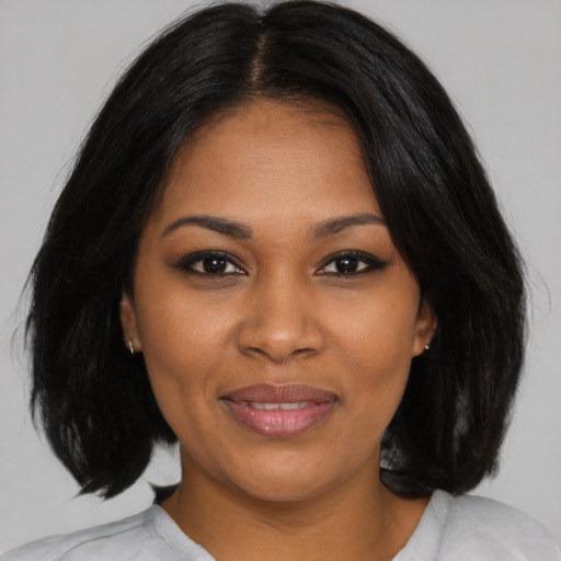 Joyful black young-adult female with medium  black hair and brown eyes