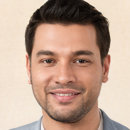 Joyful white young-adult male with short  brown hair and brown eyes