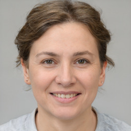 Joyful white adult female with short  brown hair and brown eyes