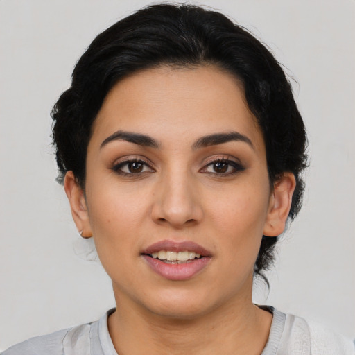 Joyful latino young-adult female with short  black hair and brown eyes