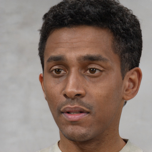 Neutral black young-adult male with short  black hair and brown eyes