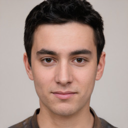 Joyful white young-adult male with short  black hair and brown eyes
