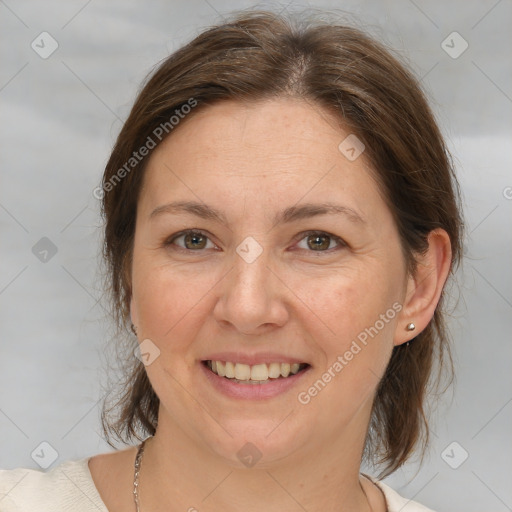 Joyful white adult female with medium  brown hair and grey eyes