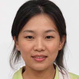 Joyful asian young-adult female with medium  brown hair and brown eyes