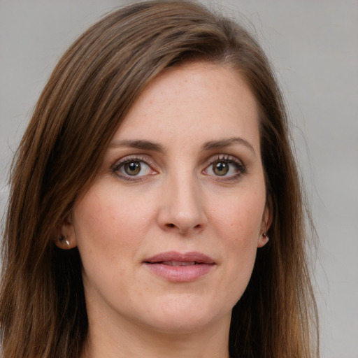 Joyful white young-adult female with long  brown hair and green eyes