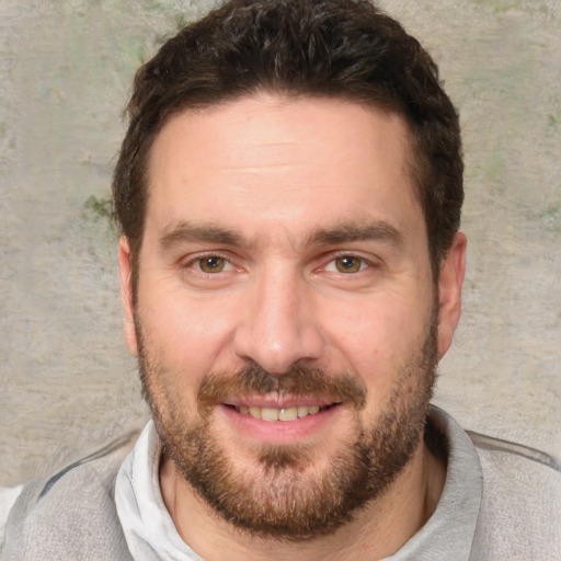 Joyful white adult male with short  brown hair and brown eyes