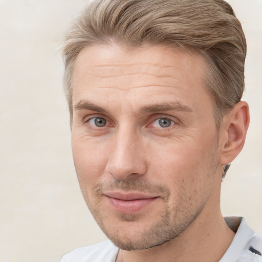 Joyful white adult male with short  brown hair and grey eyes