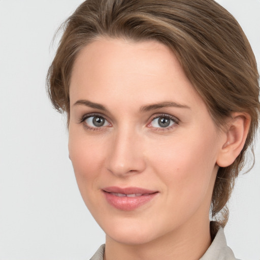 Joyful white young-adult female with medium  brown hair and grey eyes