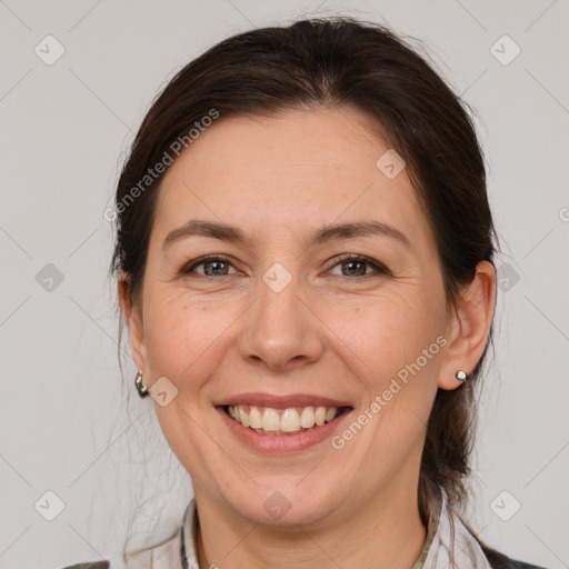 Joyful white adult female with medium  brown hair and grey eyes