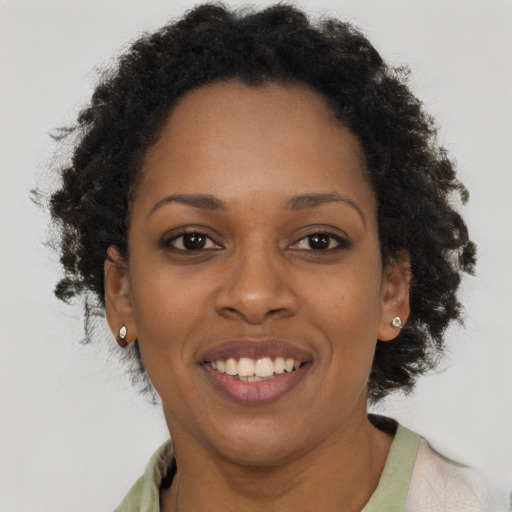 Joyful black young-adult female with short  brown hair and brown eyes