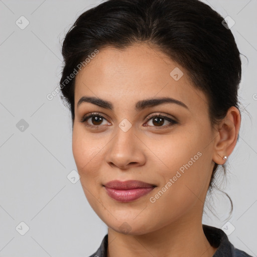 Joyful latino young-adult female with long  brown hair and brown eyes