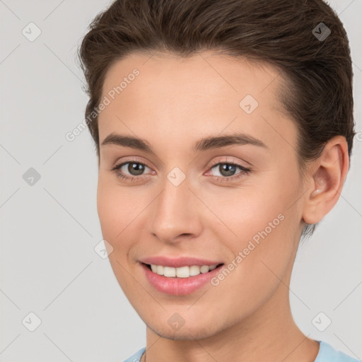 Joyful white young-adult female with short  brown hair and brown eyes