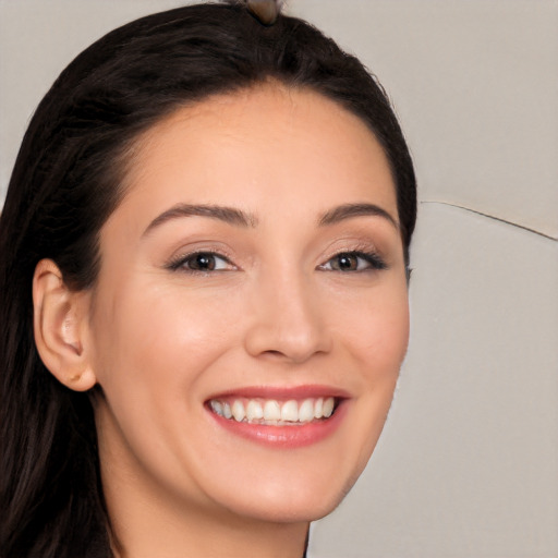 Joyful white young-adult female with long  black hair and brown eyes