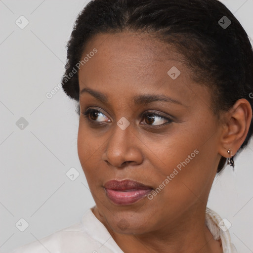 Joyful black young-adult female with short  brown hair and brown eyes