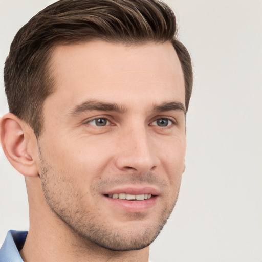 Joyful white young-adult male with short  brown hair and grey eyes