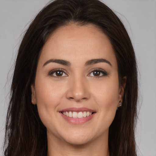 Joyful white young-adult female with long  brown hair and brown eyes