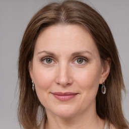 Joyful white adult female with long  brown hair and grey eyes