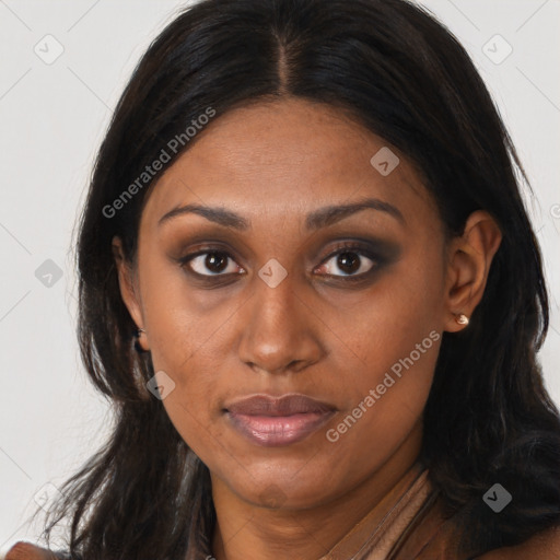 Joyful black young-adult female with long  brown hair and brown eyes