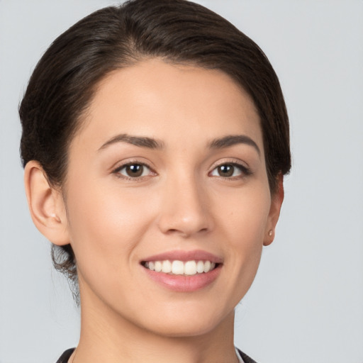 Joyful white young-adult female with short  brown hair and brown eyes